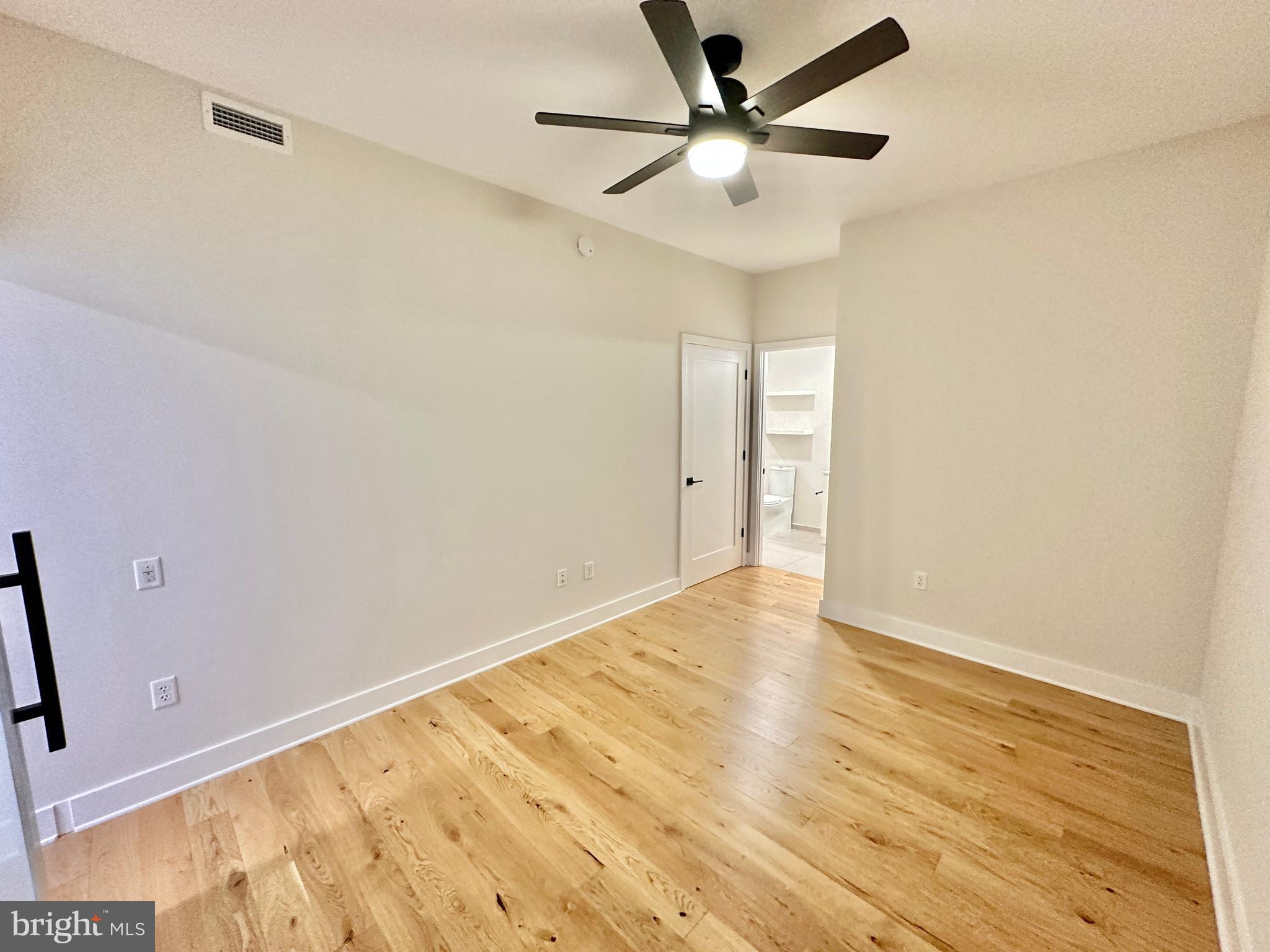 1211 Van Street Southeast, Unit 1201 Washington, DC 20003 - Photo 28 of 60 an empty room with wooden floor and windows