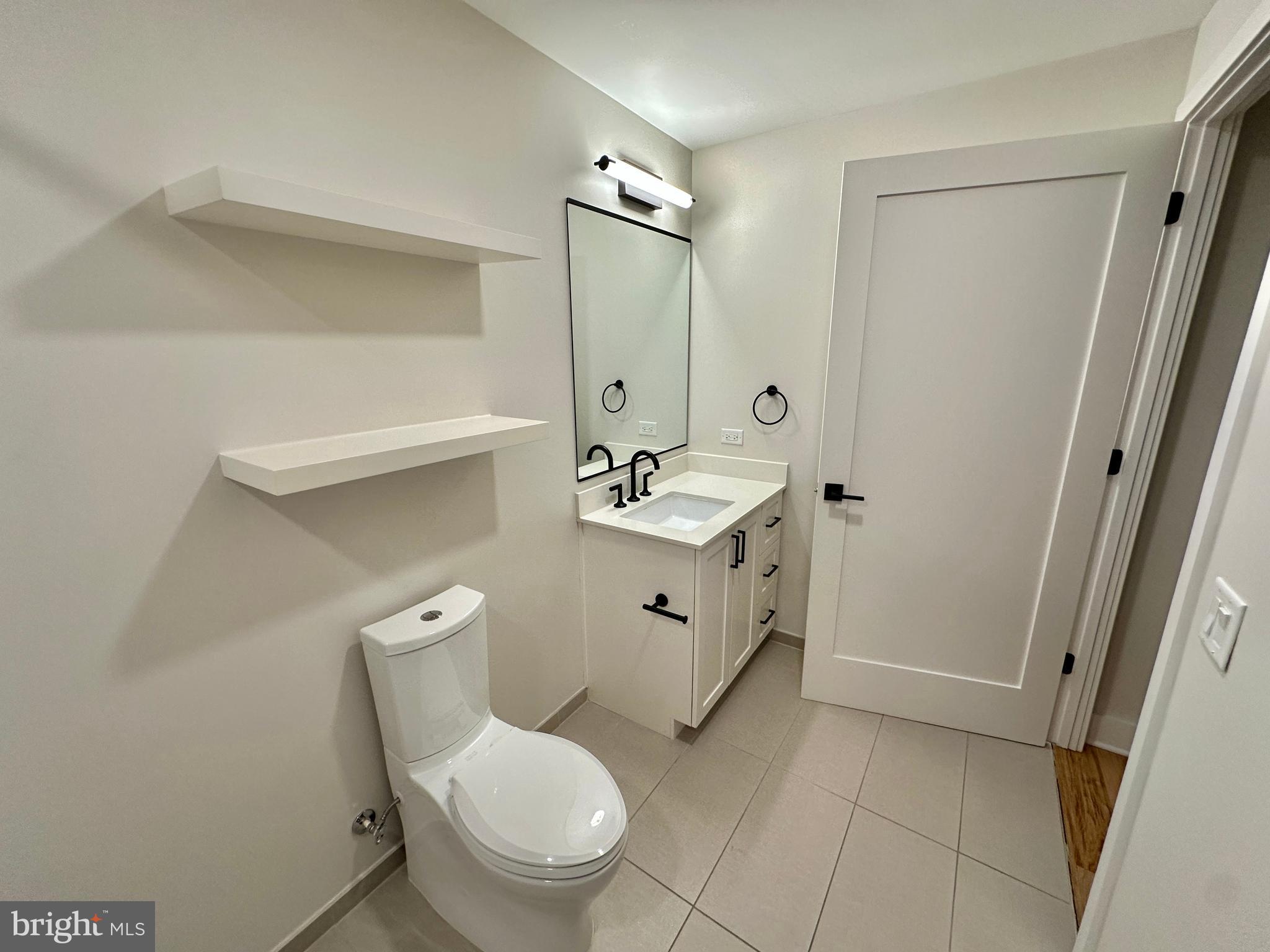 1211 Van Street Southeast, Unit 1201 Washington, DC 20003 - Photo 33 of 60 a white toilet sitting next to a bathroom sink