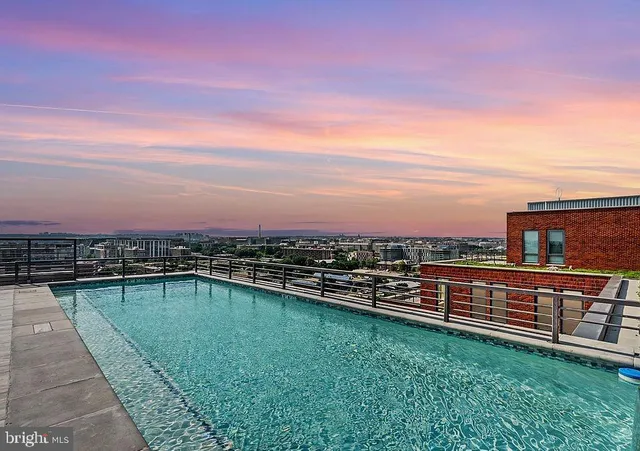 a kitchen with a table and chairs a stove and a microwave