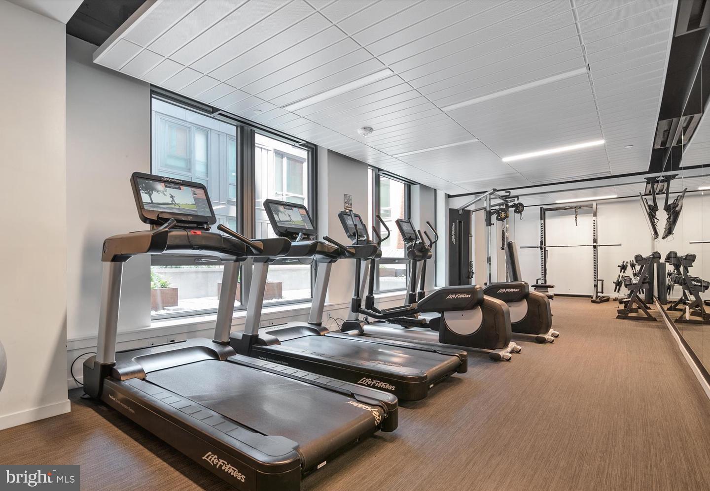 1211 Van Street Southeast, Unit 1201 Washington, DC 20003 - Photo 51 of 60 a room with gym equipment and large window
