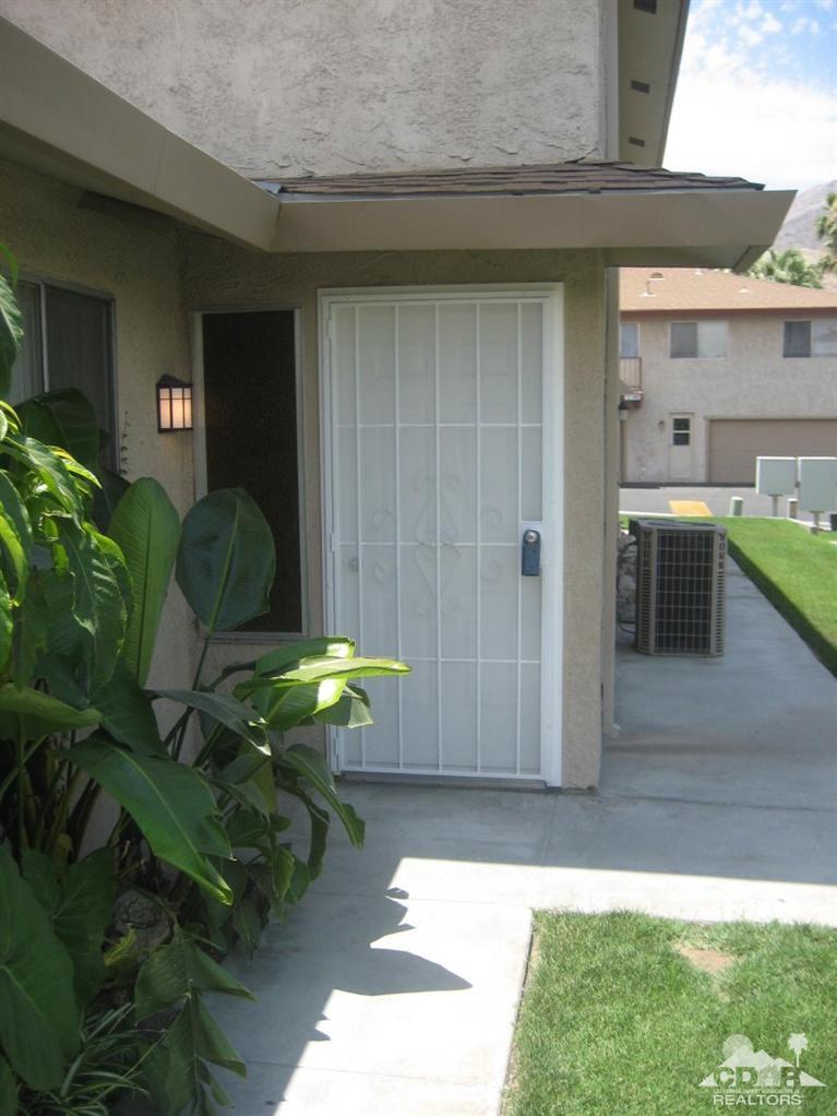 a backyard of a house with table and chairs
