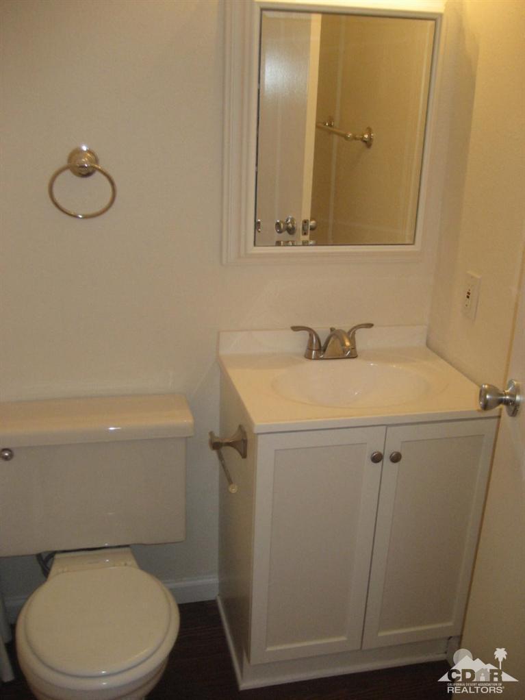 72694 Eagle Road, Unit 3 Palm Desert, CA 92260 - Photo 14 of 35 a bathroom with a sink mirror vanity and toilet
