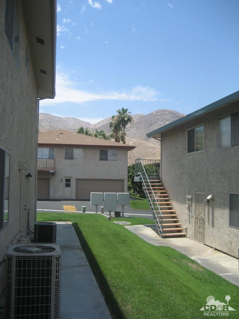72694 Eagle Road, Unit 3 Palm Desert, CA 92260 - Photo 23 of 35 a front view of a house with a yard