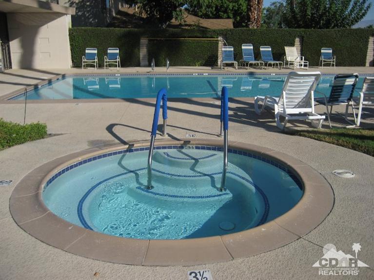 72694 Eagle Road, Unit 3 Palm Desert, CA 92260 - Photo 27 of 35 a view of a swimming pool with a chairs