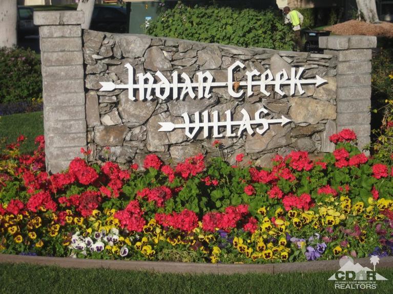 72694 Eagle Road, Unit 3 Palm Desert, CA 92260 - Photo 34 of 35 a street sign that is in front of flowers