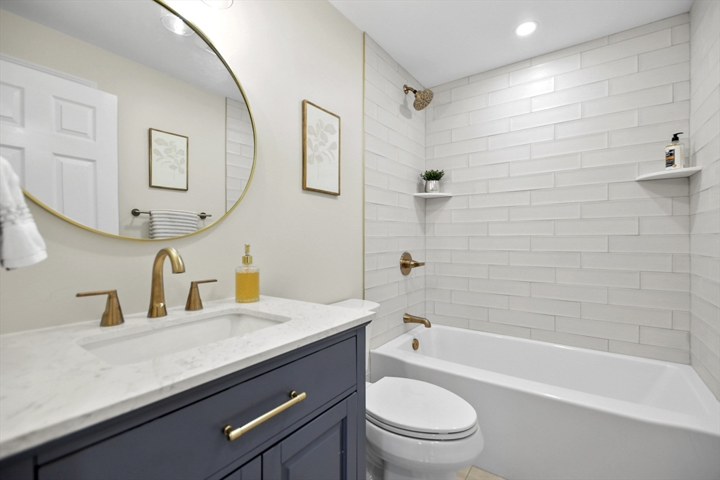 21 Woodside Road Billerica, MA 01862 - Photo 14 of 34 a bathroom with a granite countertop bathtub sink vanity mirror and toilet