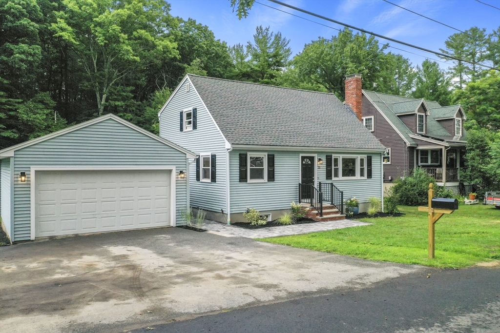 21 Woodside Road Billerica, MA 01862 - Photo 2 of 34 a front view of a house with a yard and garage