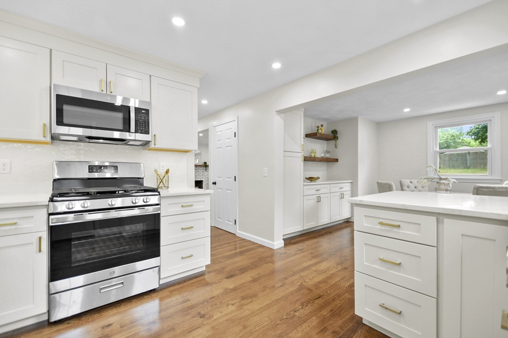21 Woodside Road Billerica, MA 01862 - Photo 8 of 34 a kitchen with stainless steel appliances granite countertop a stove microwave and sink
