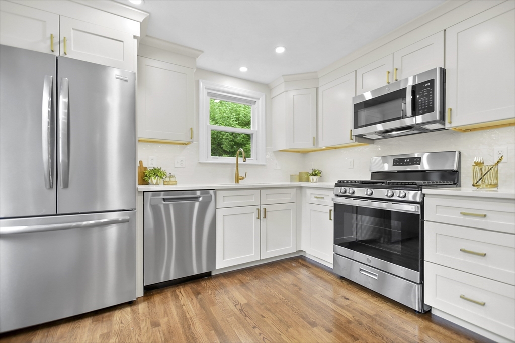 21 Woodside Road Billerica, MA 01862 - Photo 9 of 34 a kitchen with stainless steel appliances a stove a microwave and a refrigerator