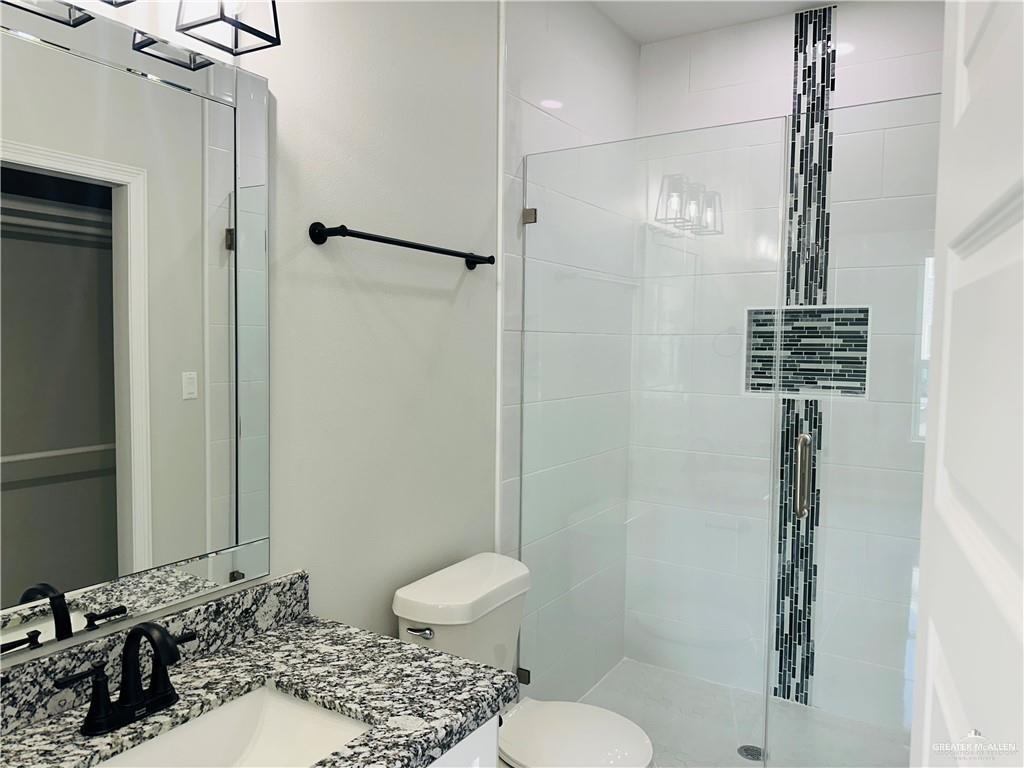 5510 North Crown Point Pharr, TX 78577 - Photo 11 of 14 a bathroom with a sink toilet and shower