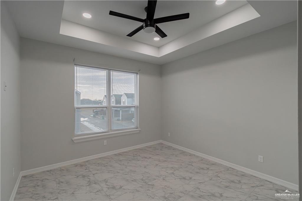 5510 North Crown Point Pharr, TX 78577 - Photo 13 of 14 an empty room with a ceiling fan and windows
