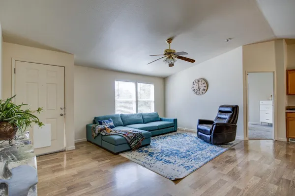 a living room with furniture and wooden floor
