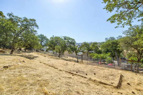 an aerial view of house with yard and mountain view in back