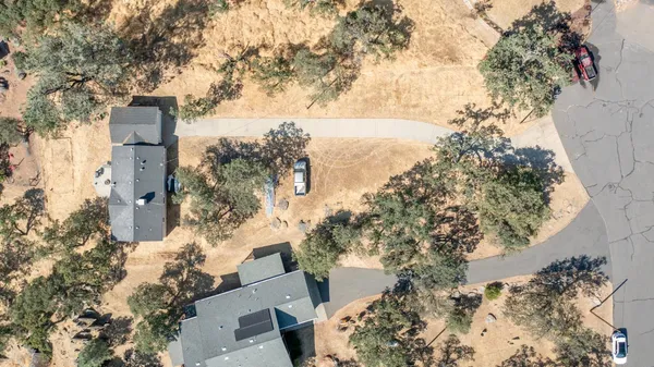 an aerial view of residential house and sandy dunes