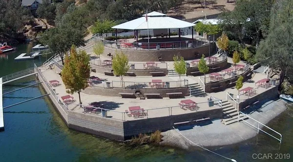 an aerial view of ocean residential house with outdoor space and trees all around