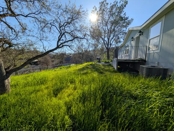 a view of balcony with wooden floor and fence