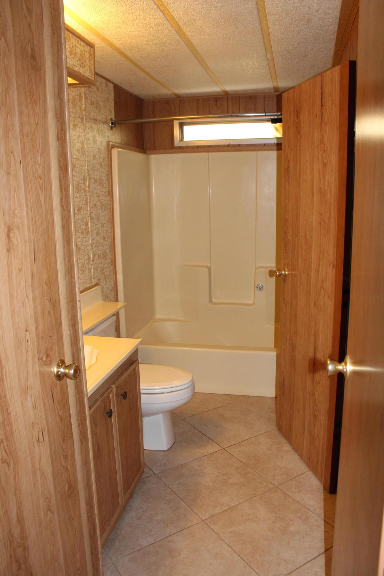 81641 Ave 48, Unit 95 Indio, CA 92201 - Photo 14 of 25 a bathroom with a toilet a sink and shower