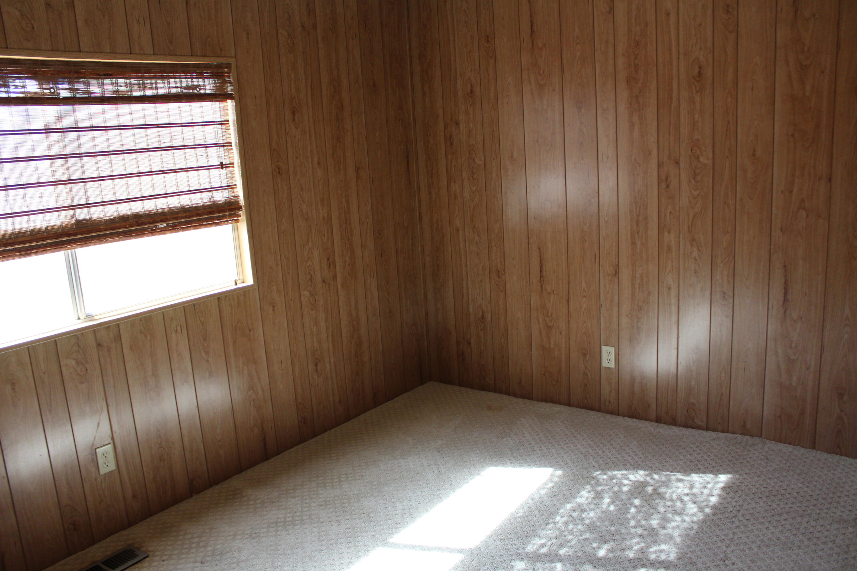 81641 Ave 48, Unit 95 Indio, CA 92201 - Photo 16 of 25 a view of an empty room with wooden floor and window