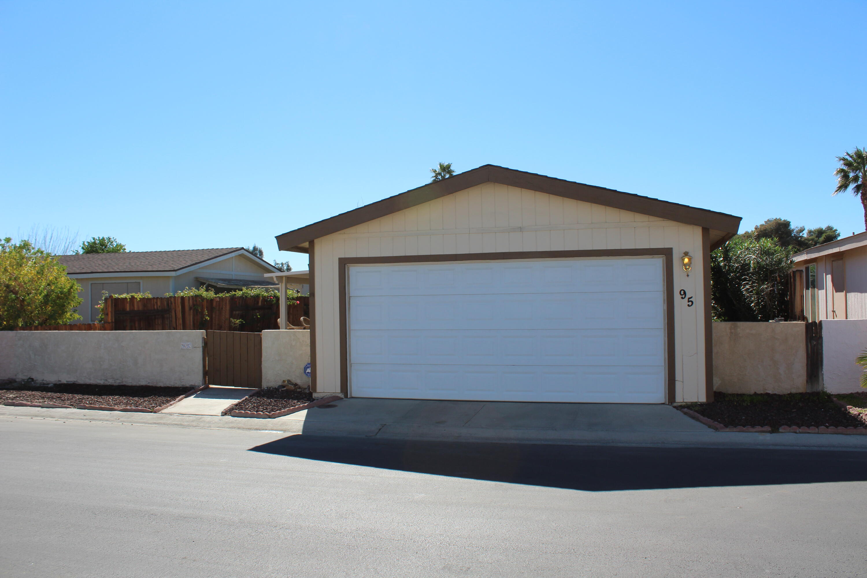 81641 Ave 48, Unit 95 Indio, CA 92201 - Photo 2 of 25 a front view of a house with a garage