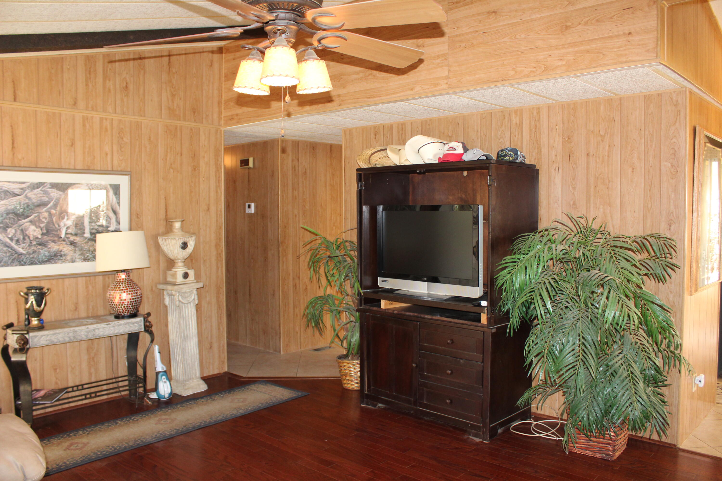 81641 Ave 48, Unit 95 Indio, CA 92201 - Photo 7 of 25 a living room with furniture and a flat screen tv