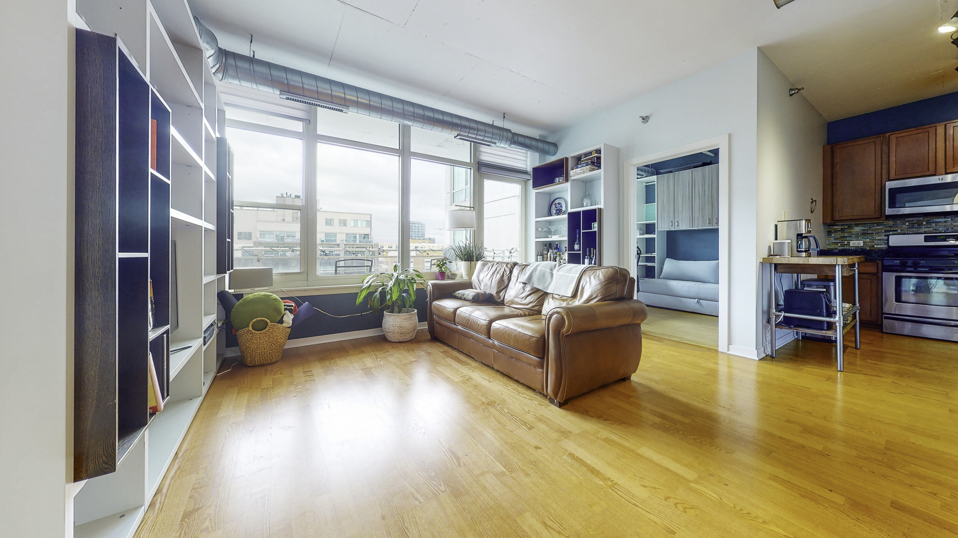 909 West Washington Boulevard, Unit 804 Chicago, IL 60607 - Photo 3 of 23 a living room with furniture and a floor to ceiling window