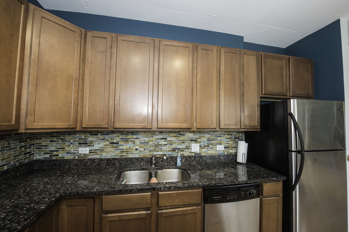 909 West Washington Boulevard, Unit 804 Chicago, IL 60607 - Photo 9 of 23 a kitchen with granite countertop stainless steel appliances a refrigerator sink and cabinets