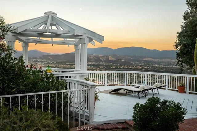 a living room with furniture fireplace and a large window