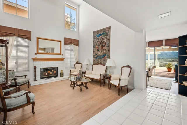 a living room with furniture kitchen view and large window