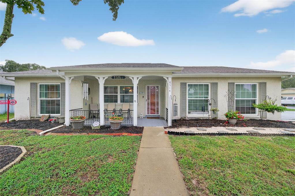 8514 Honeybee Lane Port Richey, FL 34668 - Photo 1 of 1 a front view of house with a garden and patio