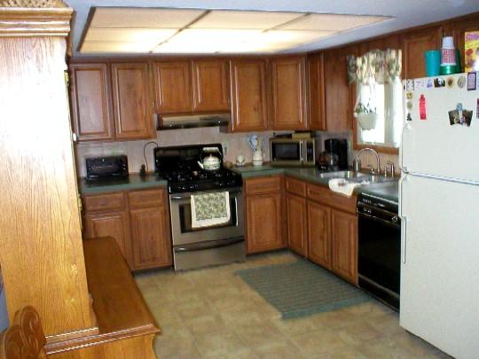 2383 Gold Key Estate Milford, PA 18337 - Photo 2 of 3 a kitchen with stainless steel appliances granite countertop a stove refrigerator sink and cabinets