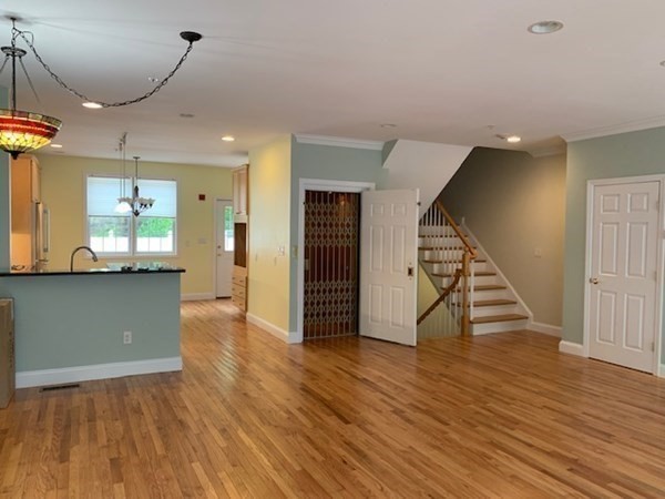 3 Dansereau Place, Unit 3 Middleton, MA 01949 - Photo 12 of 34 a view of a livingroom with wooden floor and stairs