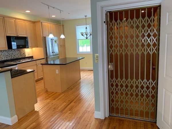 3 Dansereau Place, Unit 3 Middleton, MA 01949 - Photo 13 of 34 a kitchen with granite countertop wooden floor a refrigerator and a sink