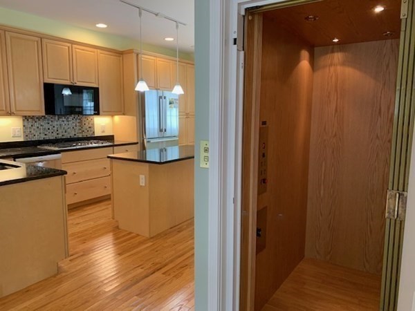 3 Dansereau Place, Unit 3 Middleton, MA 01949 - Photo 14 of 34 a kitchen with stainless steel appliances granite countertop white cabinets and wooden floor