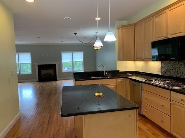 3 Dansereau Place, Unit 3 Middleton, MA 01949 - Photo 16 of 34 a kitchen with stainless steel appliances granite countertop a sink a stove and a wooden floors