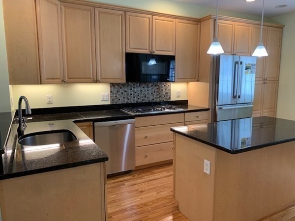 3 Dansereau Place, Unit 3 Middleton, MA 01949 - Photo 18 of 34 a kitchen with granite countertop a sink a stove and cabinets