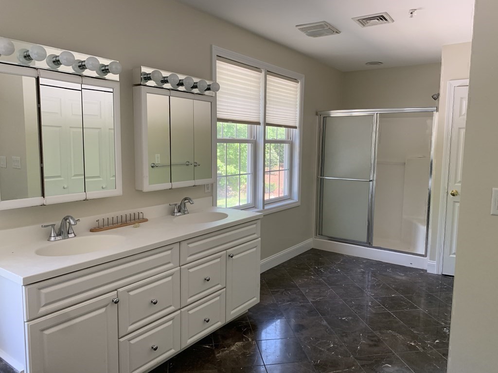 3 Dansereau Place, Unit 3 Middleton, MA 01949 - Photo 22 of 34 a bathroom with a double vanity sink and mirror with window