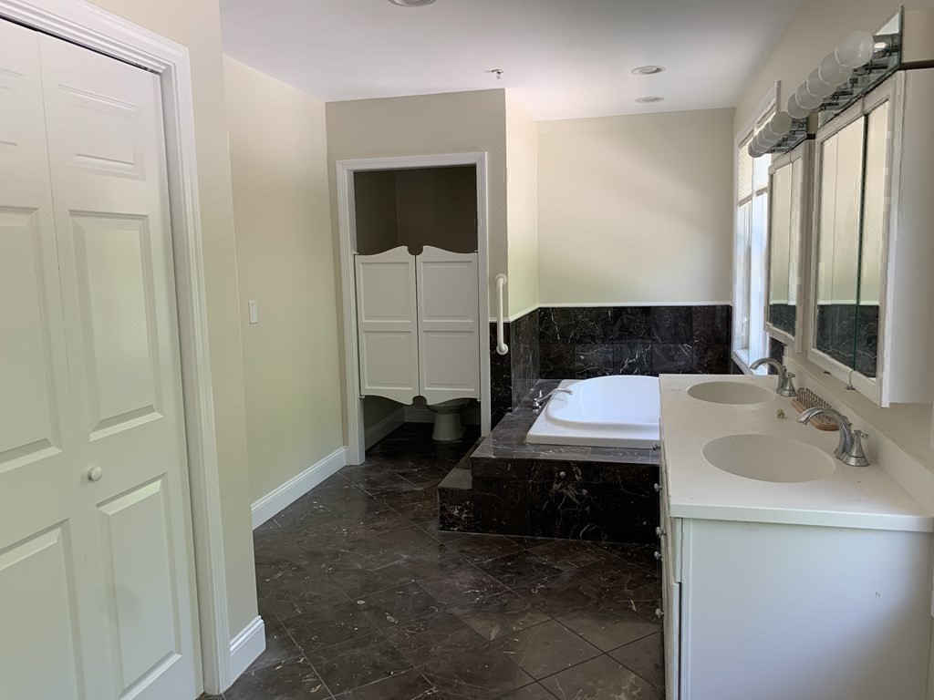 3 Dansereau Place, Unit 3 Middleton, MA 01949 - Photo 23 of 34 a bathroom with a sink and a mirror