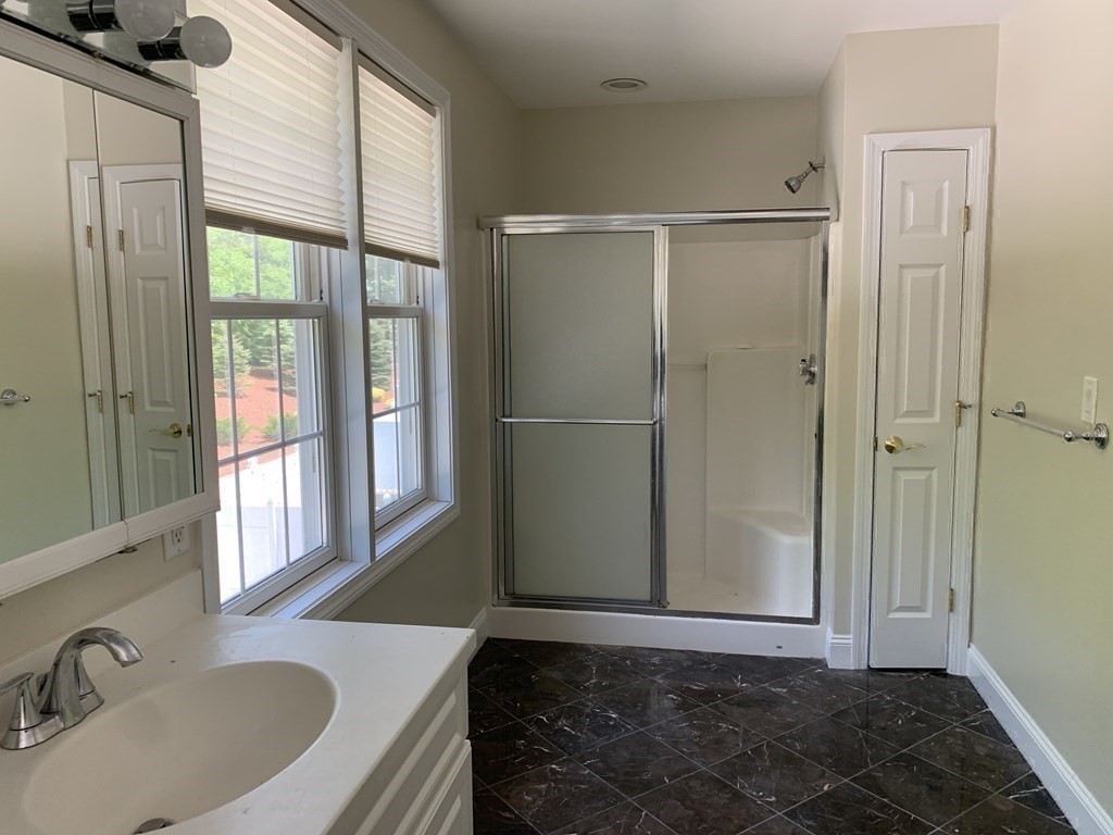 3 Dansereau Place, Unit 3 Middleton, MA 01949 - Photo 25 of 34 a bathroom with a bathtub and a sink
