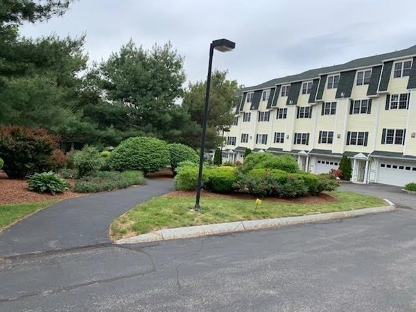 3 Dansereau Place, Unit 3 Middleton, MA 01949 - Photo 4 of 34 a front view of a building with garden and trees