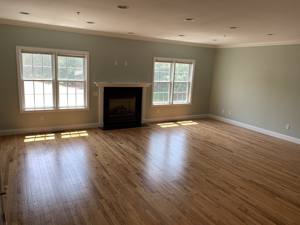 3 Dansereau Place, Unit 3 Middleton, MA 01949 - Photo 6 of 34 an empty room with wooden floor and windows