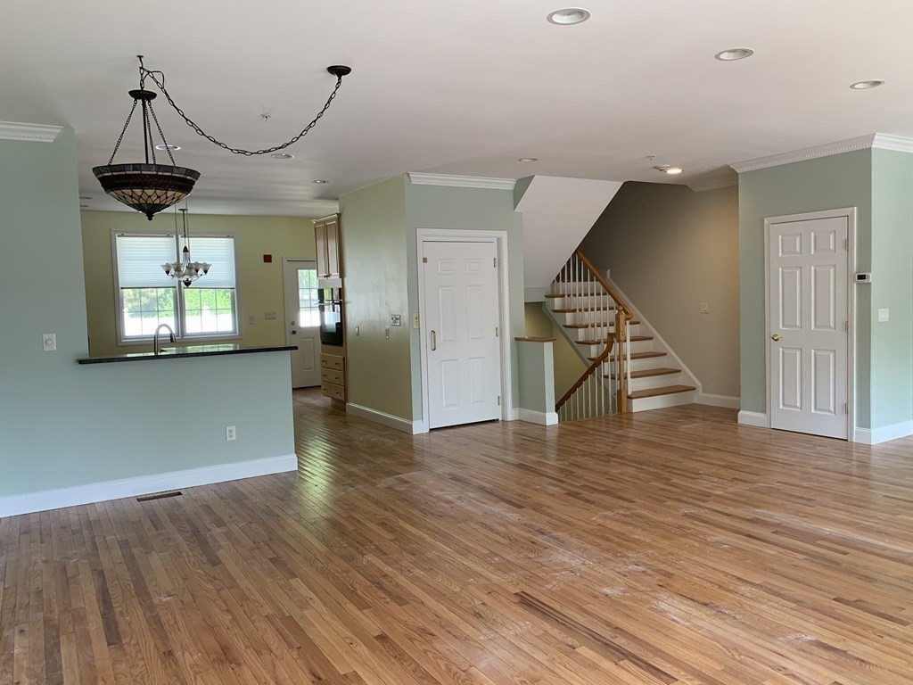 3 Dansereau Place, Unit 3 Middleton, MA 01949 - Photo 8 of 34 a view of empty room with wooden floor and windows