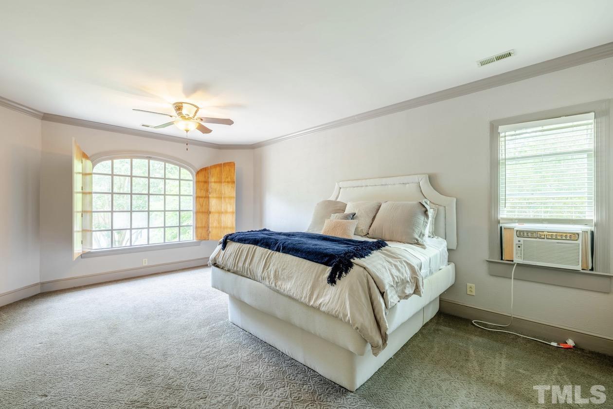 4205 Swarthmore Road Durham, NC 27707 - Photo 12 of 33 a bed sitting in a bedroom next to a window