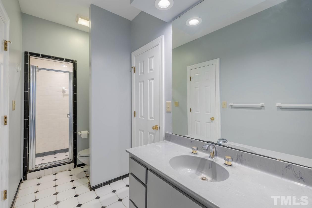 4205 Swarthmore Road Durham, NC 27707 - Photo 19 of 33 a bathroom with a sink a toilet and shower