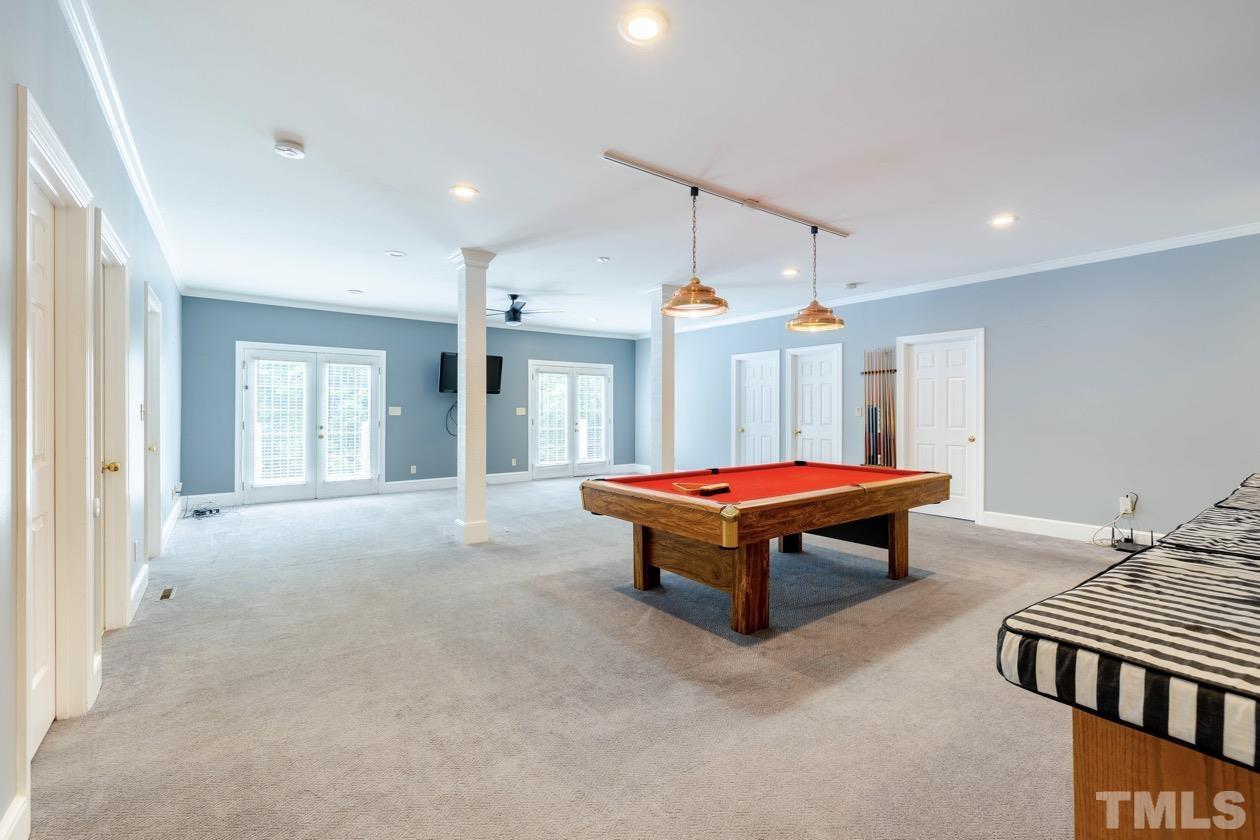 4205 Swarthmore Road Durham, NC 27707 - Photo 24 of 33 a living room with a bed furniture and a chandelier