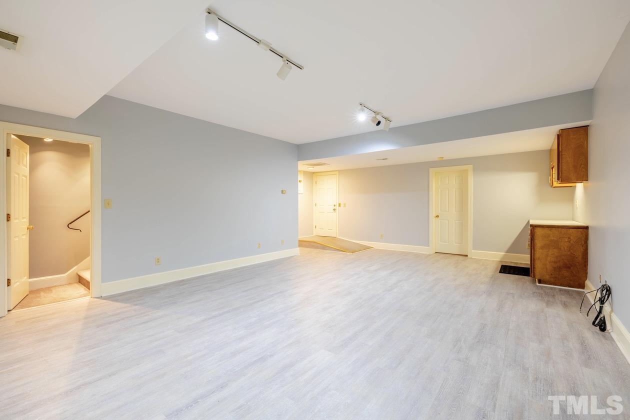4205 Swarthmore Road Durham, NC 27707 - Photo 26 of 33 a view of an empty room with wooden floor and a window