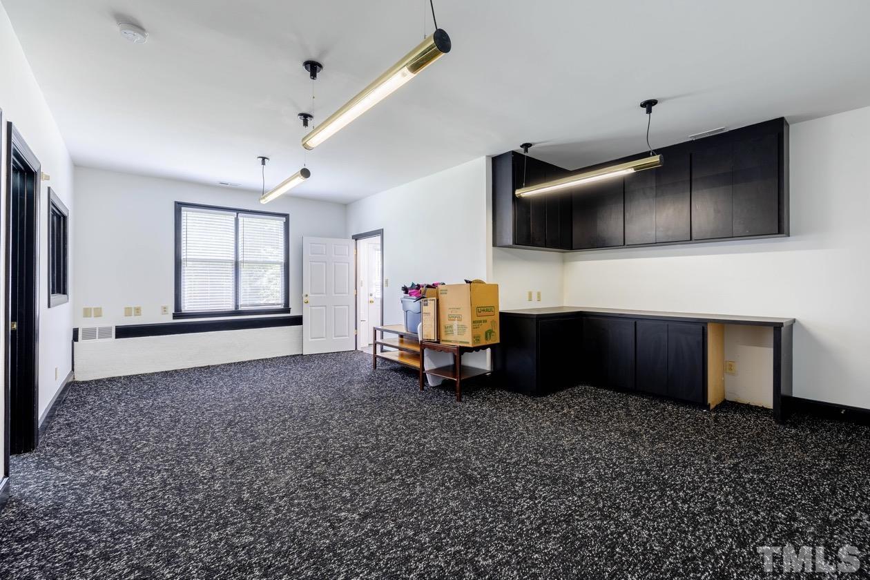 4205 Swarthmore Road Durham, NC 27707 - Photo 28 of 33 a living room with furniture and a flat screen tv