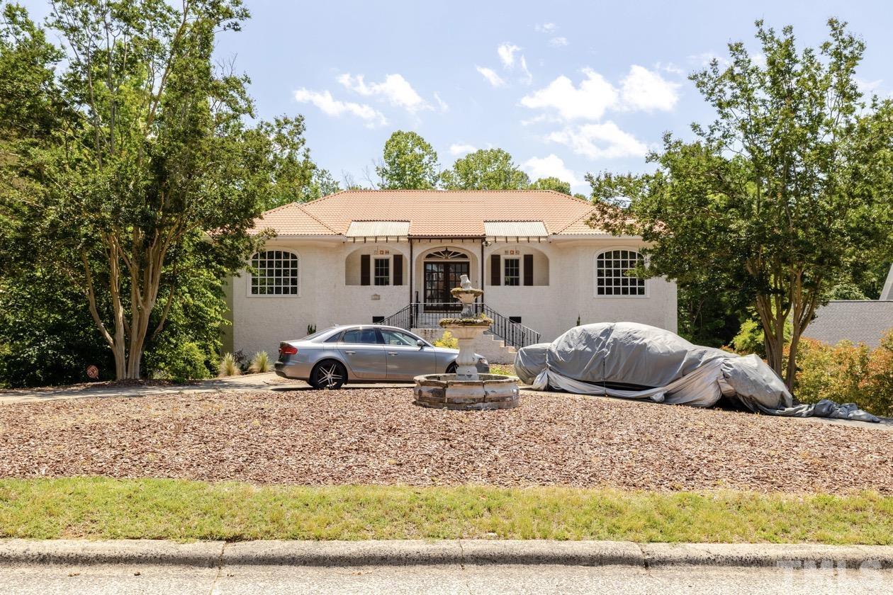 4205 Swarthmore Road Durham, NC 27707 - Photo 32 of 33 a front view of house with yard outdoor seating and covered with trees