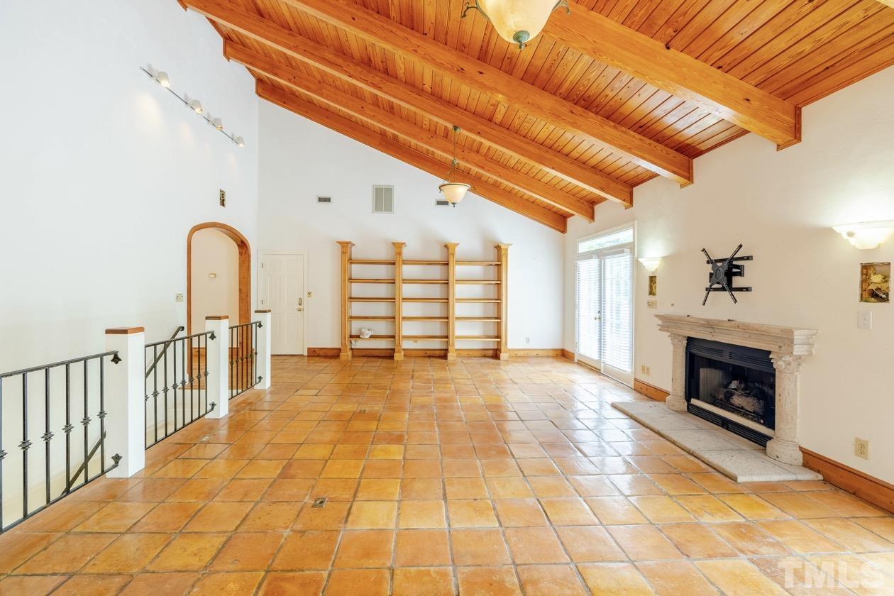 4205 Swarthmore Road Durham, NC 27707 - Photo 7 of 33 a view of an empty room with wooden floor and a fireplace