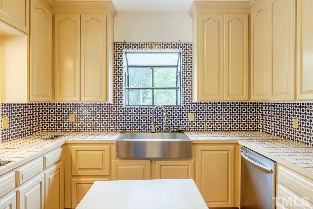 4205 Swarthmore Road Durham, NC 27707 - Photo 10 of 33 a bathroom with a sink a mirror and a shower