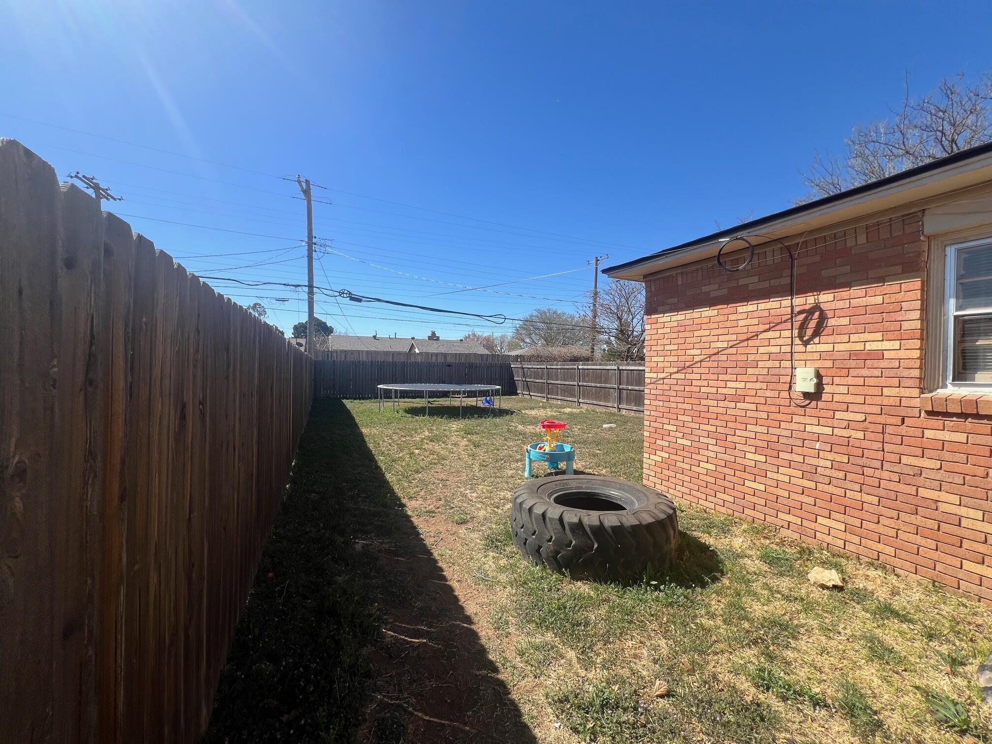 4403 31st Street, Unit A Lubbock, TX 79410 - Photo 11 of 11 a backyard of a house with a table and chairs